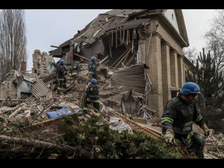 Ukrainian firefighters work at a damaged hospital maternity ward in Vilniansk, Zaporizhzhia region, Ukraine, after a Russian rocket struck the hospital in eastern Ukraine, killing a newborn boy and critically injuring a doctor on Wednesday.
