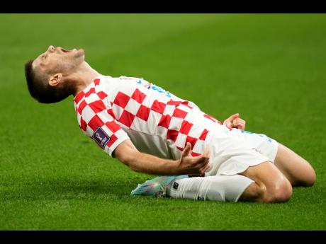 Croatia’s Andrej Kramaric celebrates after scoring his side’s opening goal during the World Cup Group F match between Croatia and Canada, at the Khalifa International Stadium in Doha, Qatar yesterday.