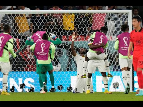 Ghanaian players celebrate after their World Cup group H sfootball match against South Korea at the Education City Stadium in Al Rayyan , Qatar this afternoon.
