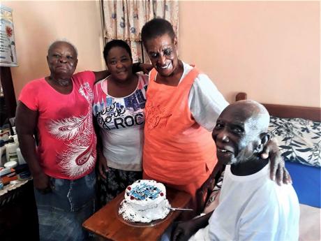 Credit: Contributed Aldin ‘Robbie’ Robinson with wife and friends at his Discovery Bay residence: L-R, Mervis Gordon, Evelyn Higgins, and wife Mrs. Margaret Robinson