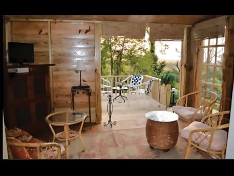 The interior of cozy simplicity opens to the outdoor deck.