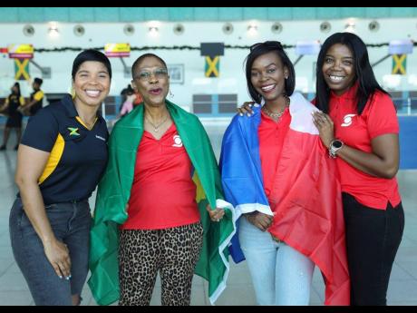 Off to Qatar to experience the 2022 World Cup were Dr Erica Gordon-Veitch (second left) and Philippa Temple (second right), lucky Scotiabank customers who won the top prize in the Scotiabank & Visa ‘Fill Qatar with Passion’ promotion. Seeing them off a