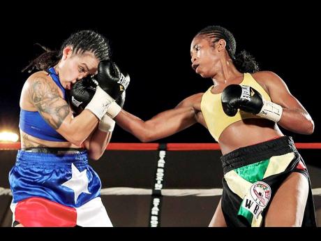 
Alicia Ashley (right) lands with a right uppercut during a World Boxing Council super bantamweight title fight against American Christina Ruiz in Bronx, New York, on July 23 2011.