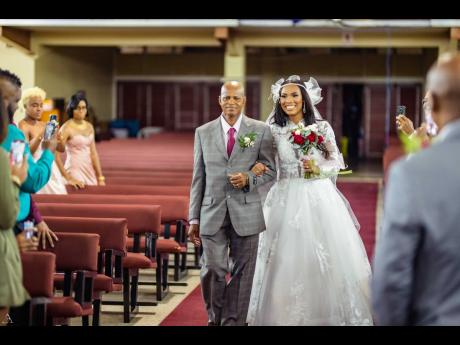 The beautiful bride is escorted up the aisle by her father, Howard Myers.