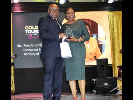 Jennifer Griffith, permanent secretary in the Ministry of Tourism, accepts the trophy for her ‘sterling contribution to the recovery of Jamaica’s tourism during the COVID-19 pandemic and for the coordination of the tourism resilient corridors and servi