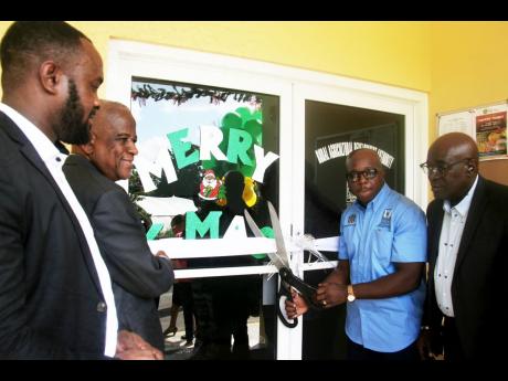 Credit: Bryan Miller Minister of Agriculture and Fisheries, Pearnel Charles Jnr (2nd right) prepares to cut the ribbon to officially declare open the newly constructed RADA office in Lucea, Hanover. Looking on are, from left; Mayor of Lucea, Sheridan Samuels, Minister of Stat