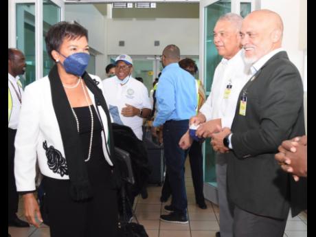 Jamaica's Ambassador to the United States of America (USA), Audrey Marks (left) is greeted by Deputy Director of Tourism, Donnie Dawson (centre) and Jamaica Hotel and Tourism Association President, Robin Russell, on the arrival of the inaugural flight from