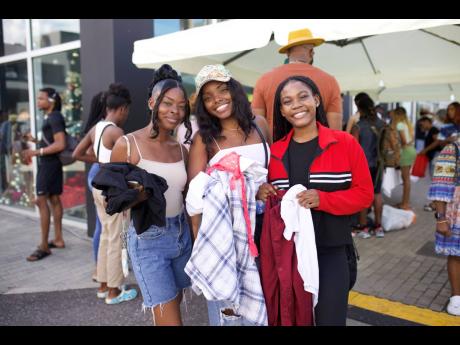 Happy customers with their thrifted items from the New Wave Celebrity Closet.