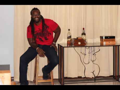 
Proud of the finished product, Craigy T sits beside ‘Emancipation: A Woman Freed’, one of his signature pieces. 