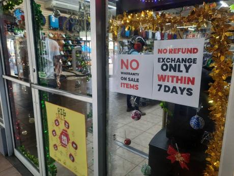 Credit: Photo by Corey Robinson Two signs at the entrance to this store warn customers of the terms under which goods are sold.