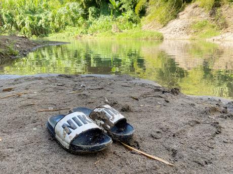 Credit: Photo by Ainsworth Morris The slippers of the late Remo Douglas, a 34-year-old resident of United Kingdom, who died after drowning in Thomas River, Clarendon, on Friday.