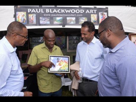 Chief Technical Director in the Ministry of Tourism, David Dobson (left); Executive Director, Tourism Enhancement Fund, Dr  Carey Wallace (second right); and Executive Director, Tourism Product Development Company (TPDCo), Wade Mars (right), look on as art