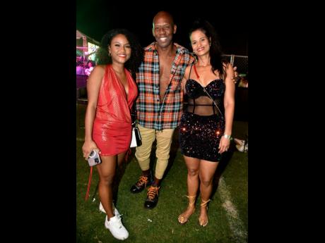 Credit: Kenyon Hemans Member of Parliament for St Catherine North Western Hugh Graham is sandwiched by daughter Anna Graham (left) and wife Dr Cindy Graham