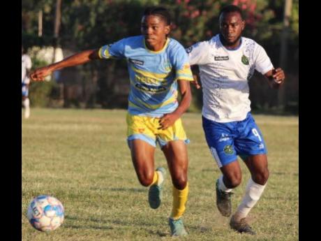Waterhouse’s midfielder Shemar Boothe gets away from the pressing Bebeto McDonald of Vere United during their Jamaica Premier League encounter at the Wembley Centre of Excellence on December 4. Waterhouse won 1-0.