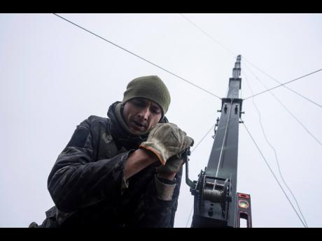 Credit: AP A Ukrainian serviceman from the 127 brigade prepares a telescopic tower with a remote camera installed on a Soviet car "Volga" that was recast to observe and correct fire on the front line near Kharkiv, Ukraine today.
