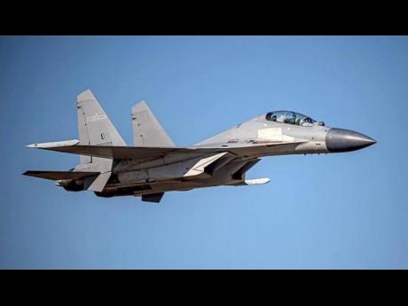 In this undated file photo released by the Taiwan Ministry of Defense, a Chinese PLA J-16 fighter jet flies in an undisclosed location. 