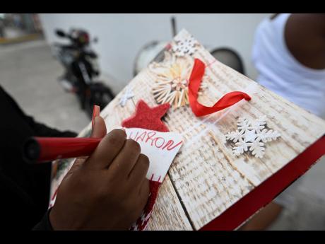 A resident addresses a gift for the Parade Gardens pixie gift exchange on Monday.