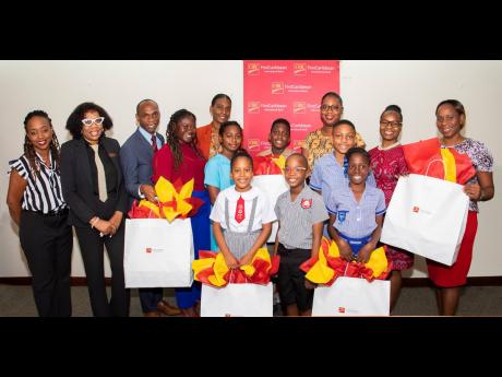 CIBC FirstCaribbean’s Marketing Manager Renee Whitehorne (left); branch managers Maggie McGann Williams – Liguanea (second left) and Debbie Henry - (LONG DASH) Manor Park (second right) with students, principals and teachers of several schools at a pre