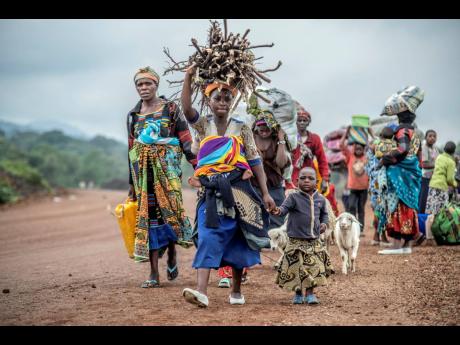 Residents flee fighting between M23 rebels and Congolese forces near Kibumba, Democratic republic of Congo, on October 29.
