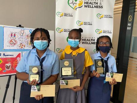 Shamara Chin (centre), student at Greater Portmore Primary and winner of the Diabetes Awareness Month Poster Competition, with Tarika-Kae Powell (right) and Tiandra Lewis of Knox Junior School, who placed second and third, respectively. 