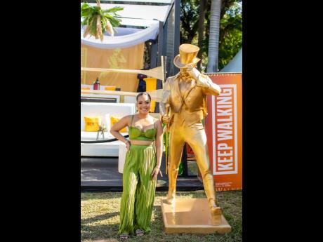 Georgia Bayley slowed her stride to snap a picture with the Johnnie Walker Striding Man at the Sunrise Breakfast Party.