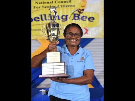 Credit: File Olga Williams, representing the parish of St Mary, proudly holds her trophy after winning the National Council for Senior Citizens, National Spelling Bee Competition for 2022.