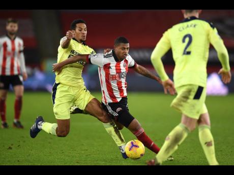 Sheffield United’s Rhian Brewster (centre)  is fouled by Newcastle’s Isaac Hayden during an English Premier League match in 2021.