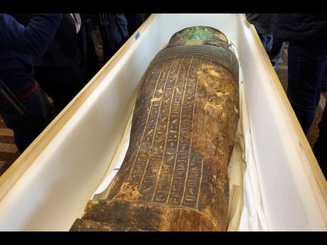 An ancient wooden sarcophagus is displayed during a handover ceremony at the foreign ministry in Cairo, Egypt,