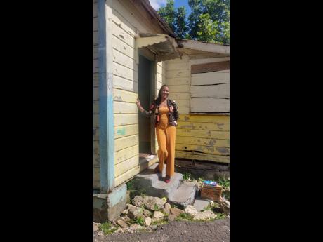 Principal of Troy Primary, Keneisha McIntosh, stands on the steps of the cottage