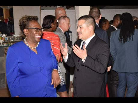 Director of Public Prosecutions (DPP) Paula Llewellyn (left) was left in stitches as she chatted with Matthew Samuda, minister without portfolio in the Ministry of Economic Growth and Job Creation.
