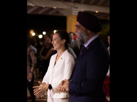Minister of Foreign Affairs and Foreign Trade Senator Kamina Johnson Smith (left) and Canada’s Minister of International Development Harjit S. Sajjan enjoy the proceedings. 