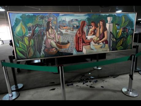 The damaged artwork titled ‘As Mulatas’, by Brazilian artist Di Cavalcanti, is displayed in the entrance hall of the presidential office at Planalto Palace.
