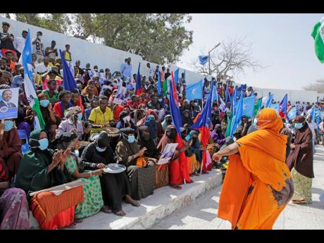 Residents and officials lead a demonstration supporting the government at Banadir stadium, Mogadishu. The government rally encouraged an uprising against the al-Shabab group amid a month-long military offensive. 