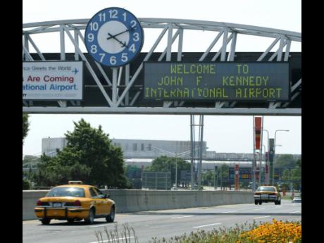 A clock at the entrance to JFK Airport in New York is pictured on August 15, 2003. Officials are investigating a close call at the New York airport that happened on Friday, January 13, between a plane that was crossing a runway and another that was prepari