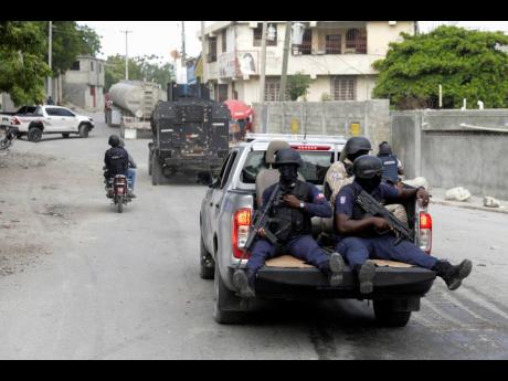 Credit: File A police convoy escort fuel trucks filled with gas as they drive from the Varreux fuel terminal, in Port-au-Prince in November 2022.