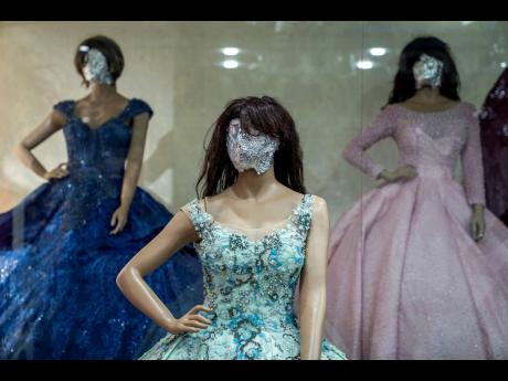 Mannequins’ heads are covered in a women’s dress store in Kabul, Afghanistan.   THIS LOOKS LIKE FACES, NOT HEADS