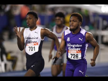 Credit: Ricardo Makyn
Kingston College’s Adrian Kerr (right) runs alongside Jamaica College’s Malique Smith-Band at the National Junior and Senior Championships at the National Stadium last year.
