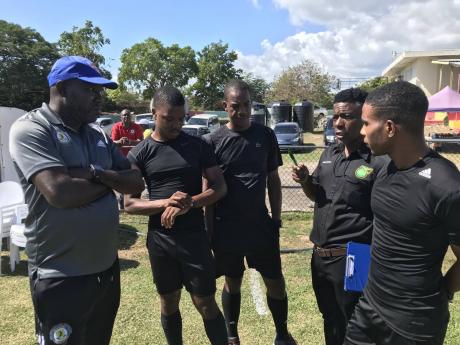 Match Commisioner Anthony Gibbs (second right) explains the situation to Mount Pleasant’s head coach Theodore Whitmore (left) and the match officials prior to the start of the Jamaica Premier League game between Chapelton Maroons and Mount Pleasant at Ef
