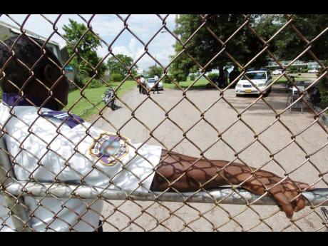 In this file photo, a security guard is seen standing at the entrance of Calabar High School.