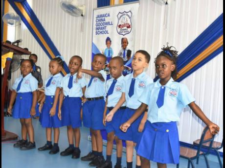 Students at the Jamaica China Goodwill Infant School, in Olympic Gardens, St Andrew, perform at the recent opening of a state-of-the-art library, sponsored by Reading Owl International.