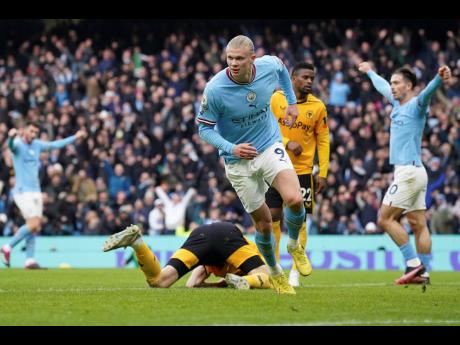 Manchester City’s Erling Haaland (centre) celebrates after scoring his side’s opening goal during the English Premier League match between Manchester City and Wolverhampton at the Etihad Stadium in Manchester, England yesterday.