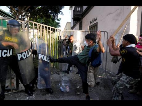 Anti-government protesters clash with police in Lima, Peru, on Tuesday.