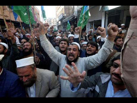 Credit: Muhammad Sajjad Supporters of Jamaat-e-Islami chant slogans during a protest against the burning of Quran, a Muslim holy book, by a Danish anti-islam activist, in Peshawar, Pakistan yesterday.