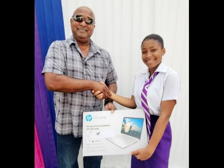 Mikayla Bartley (right) receives her technology package from Robin Rickhi, Scholarship Committee member