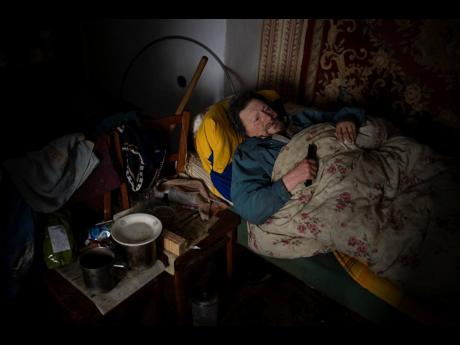 Suffering from cancer, Gennadiy Shaposhnikov, 83, rests in his partially destroyed home which was hit by Russian shelling last fall in Kalynivske, Ukraine.