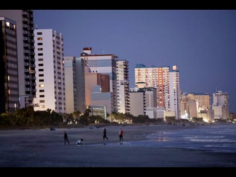People walk on the beach in Myrtle Beach. On Saturday, February 4, a Chinese balloon was shot down in the area. 