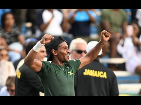 Credit: Ricardo Makyn Jamaica’s Rowland Phillips celebrates with the crowd at the Eric Bell Tennis Centre on Saturday after he dismissed Estonia’s Kristjan Tamm, 6-1, 6-1, in Davis Cup Group II qualification action.