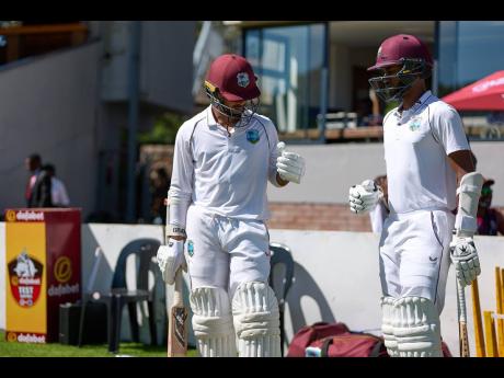 West Indies openers Tagenarine Chanderpaul (left) and his captain, Kraigg Brathwaite, get ready to enter the field of play on day four of the first Test against Zimbabwe in Bulawayo yesterday.