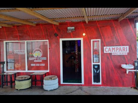The rebranded Happy Corner Sports Bar in Tobago sporting the Campari image. The Campari liquor bottle pictured at right replaced an image of Red Stripe beer that was displayed there prior to the rebranding. 