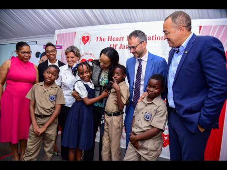 Credit: Contributed Minister of Health and Wellness Dr Christopher Tufton (right), and United Nations Children’s Fund (UNICEF), Acting Country Representative, Vicente Teran (second right), observe as Chief Education Officer (Acting), Ministry of Education and Youth, Dr Kasa